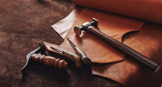 Concept background tailor shoes maker. Natural leather brown color with tools, copy space