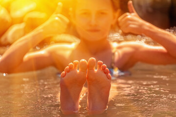 Beautiful child girl  taking a bath at mountain geysers hot springs, thermal waters. Selective...