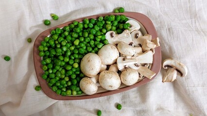 mushrooms and green peas on a table