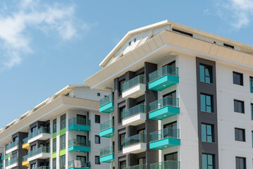 Naklejka premium Modern freshly built apartment buildings on a sunny day with blue sky.