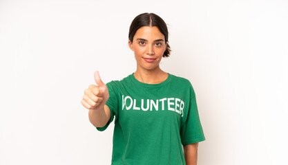 pretty hispanic woman feeling proud,smiling positively with thumbs up. ecology and volunteer concept