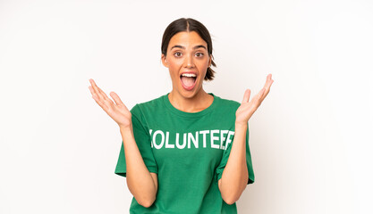pretty hispanic woman feeling happy and astonished at something unbelievable. ecology and volunteer...