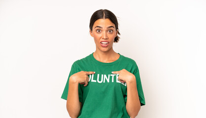 pretty hispanic woman feeling happy and pointing to self with an excited. ecology and volunteer...