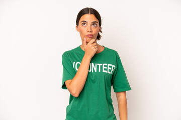 pretty hispanic woman thinking, feeling doubtful and confused. ecology and volunteer concept