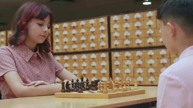 4K. Children play chess in the library