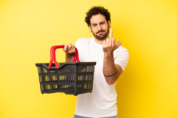 crazy bearded man feeling angry, annoyed, rebellious and aggressive. empty market basket concept