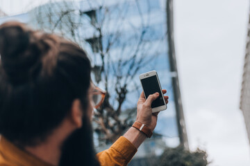 Happy young man taking a selfie photo with his smart phone
