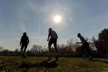Silhouettes of three runners preparing for the running