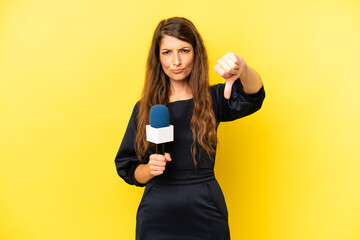 pretty caucasian woman feeling cross,showing thumbs down. tv presenter concept