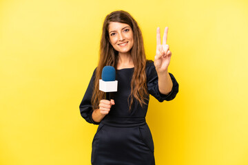 pretty caucasian woman smiling and looking happy, gesturing victory or peace. tv presenter concept