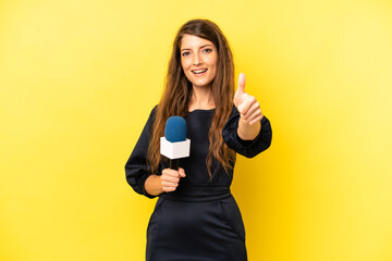 pretty caucasian woman feeling proud,smiling positively with thumbs up. tv presenter concept