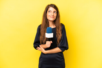 pretty caucasian woman shrugging, feeling confused and uncertain. tv presenter concept