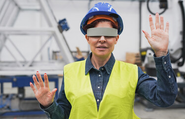Mature woman using virtual reality glasses inside robotic factory