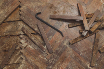 Home improvement. Removing old wooden parquet flooring using crowbar tool. Old wooden floor...