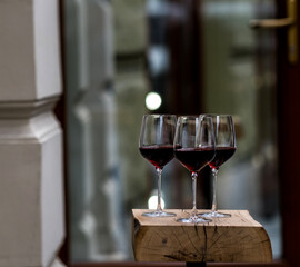 Glasses with red wine stand near the restaurant
