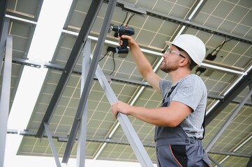 Worker installing solar panels outdoors