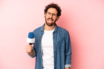crazy bearded man with cheerful and rebellious attitude, joking and sticking tongue out. presenter...
