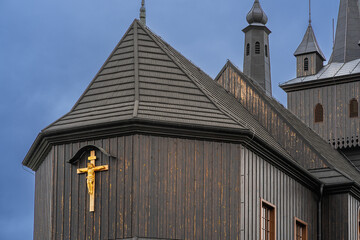 Black wood catholic christian temple on a cloudy day, dramatic rainy sky, sacrament of faith,...