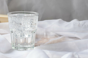 Soda water with ice in a clear glass. Copy space.