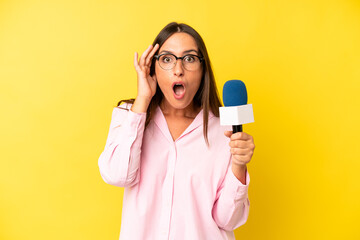 hispanic young adult woman looking surprised, realizing a new thought, idea or concept. interviewer...