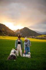 portrait of a couple in the mountains with her dogs