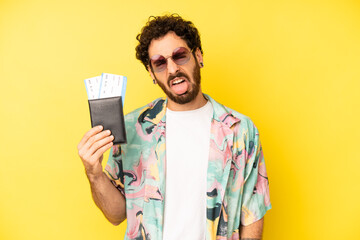 Fototapeta crazy bearded man feeling disgusted and irritated and tongue out. tourist with a passport, holidays concept obraz