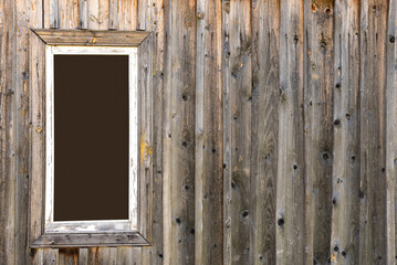 Obraz na płótnie Canvas White window frame with space for text or photos on a wooden wall.