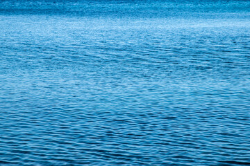 Clear calm blue sea waters surface closeup as water background