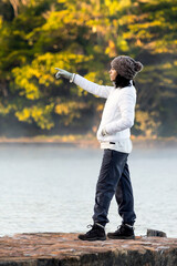 A woman contemplating the fog over the lake on a cold dawn. Life Style.