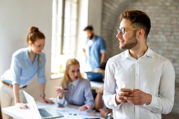 Portrait of business people having fun, working together and chatting at workplace office