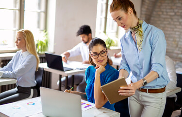 Portrait of business women working together in corporate office. Finance architect startup concept