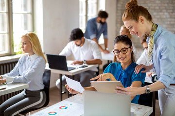 Group of happy multiethnic business people cooperating, working on meeting in corporate office
