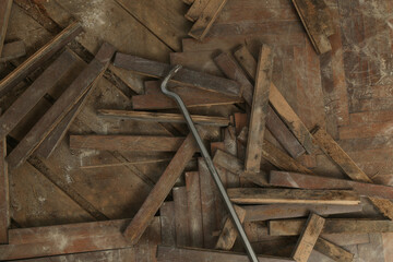 Home improvement. Removing old wooden parquet flooring using crowbar tool. Old wooden floor renovation.