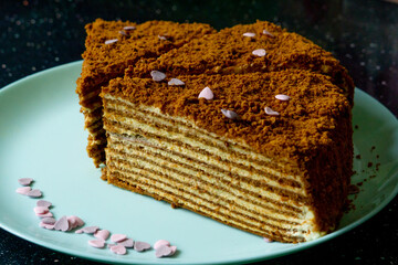 Delicious Honey Cake with sugar hearts and cream