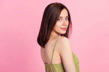 Profile photo of attractive gorgeous woman with brunette hairdo dressed khaki tank looking at camera isolated on pink color background