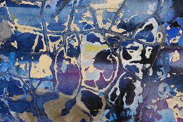 Colorful wall background with damaged paints of blue