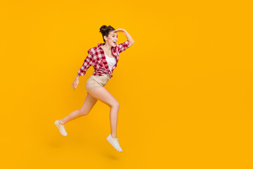 Fototapeta na wymiar Full length portrait of excited girl look empty space hand forehead isolated on yellow color background