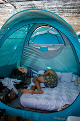 person  sleeping in a tent