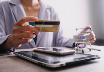 Hands holding credit card and using laptop. Online shopping