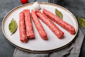 Raw meat sausage, on gray stone table background