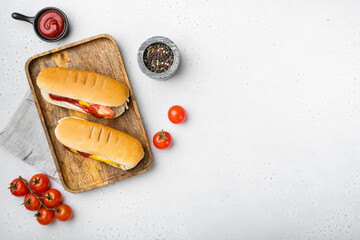 Homemade Bacon Wrapped Hot Dogs, on white stone table background, top view flat lay, with copy...