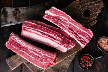 Argentinean Style Short Ribs, on old dark  wooden table background, top view flat lay