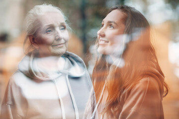 Grandmother and granddaughter women double exposure image. Young and elderly woman portrait. Love...