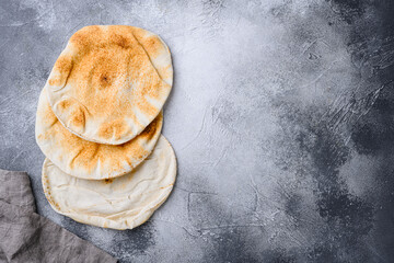 Pita flat bread set, on gray stone table background, top view flat lay, with copy space for text
