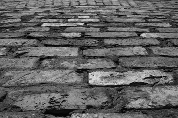 gray background, in the photo is a brick wall close-up, bottom view