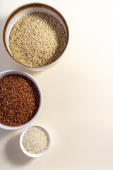 Uncooked rice assortment in bowl on white background. Top view.