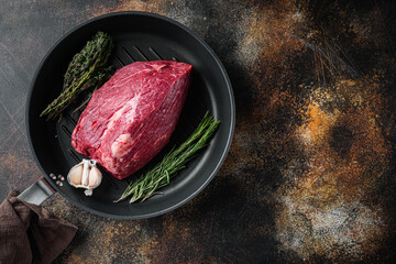 Beef meat cut raw, on frying iron pan, on old dark rustic background, top view flat lay,  with copy space for text - obrazy, fototapety, plakaty