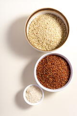 Uncooked rice assortment in bowl on white background. Top view.