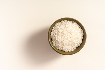 Raw rice assortment in bowl on white background. Horizontal. Place for text. Top view.