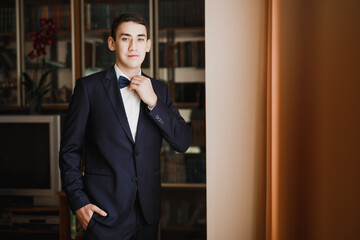 Grooms morning preparation. Handsome man getting dressed and preparing for the wedding